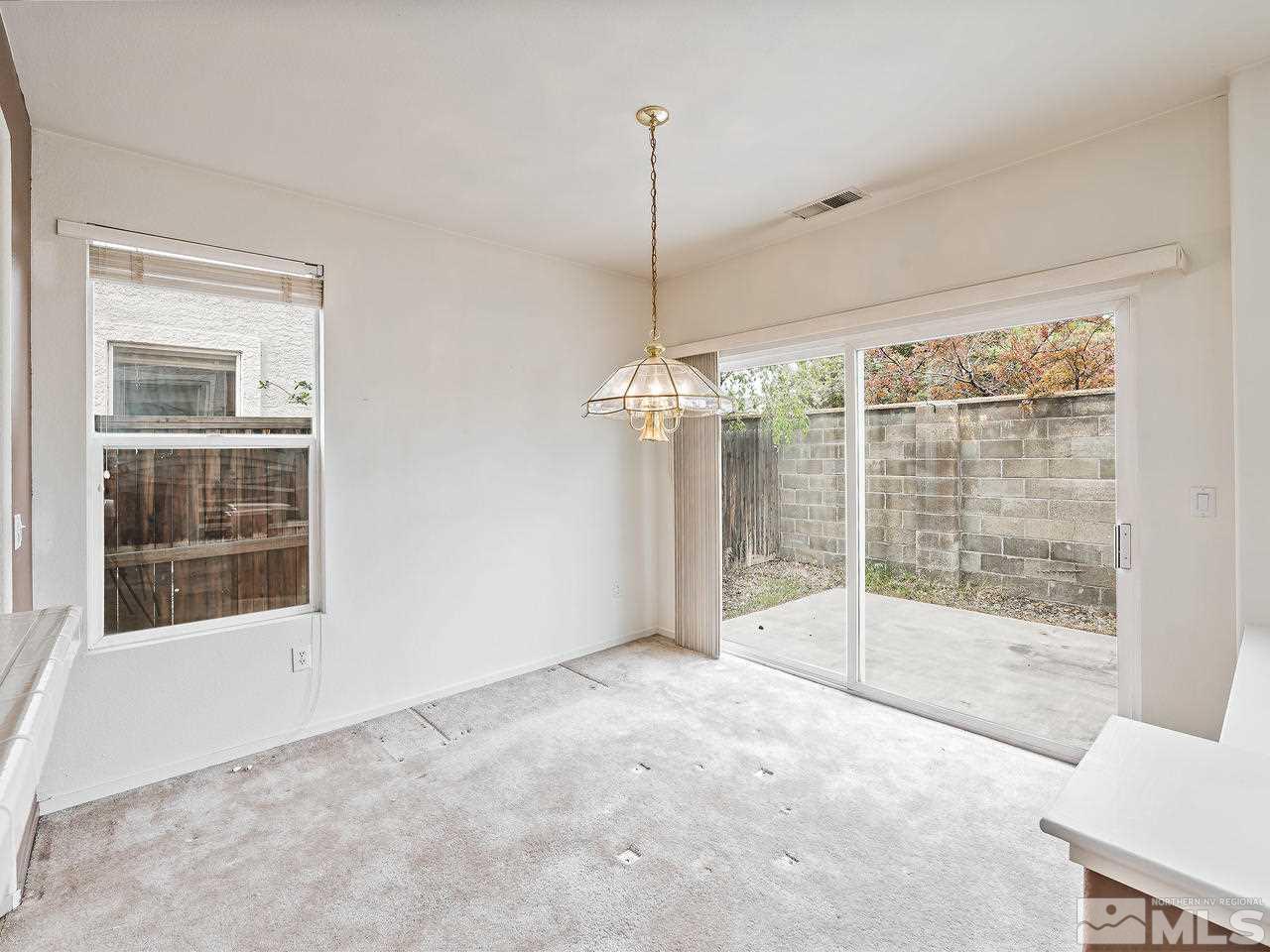 1287 Tule Drive Reno, NV 89521 - Photo 9 of 32 a view of an empty room with a glass door and windows