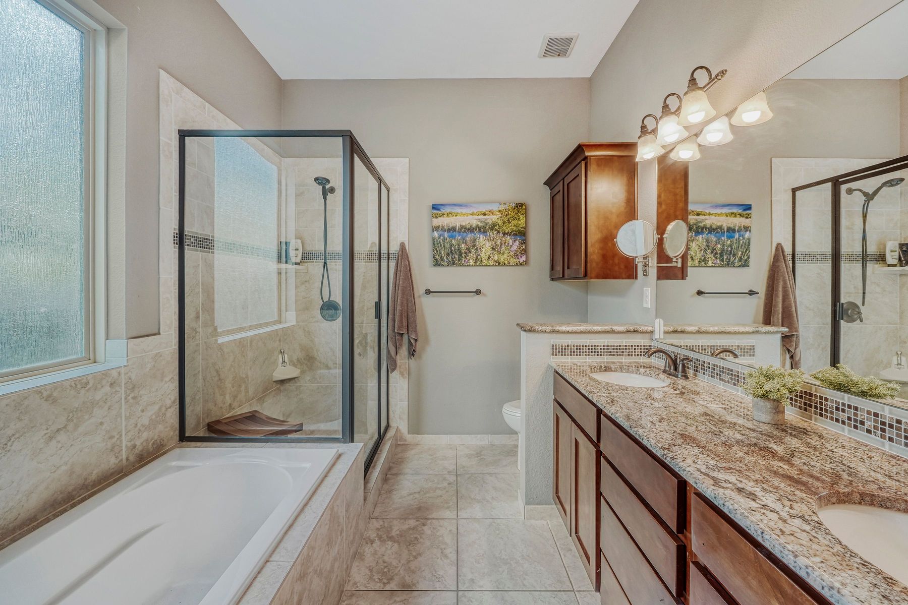 2913 Chisholm Trail Austin, TX 78734 - Photo 11 of 24 a spacious bathroom with a granite countertop sink mirror and shower