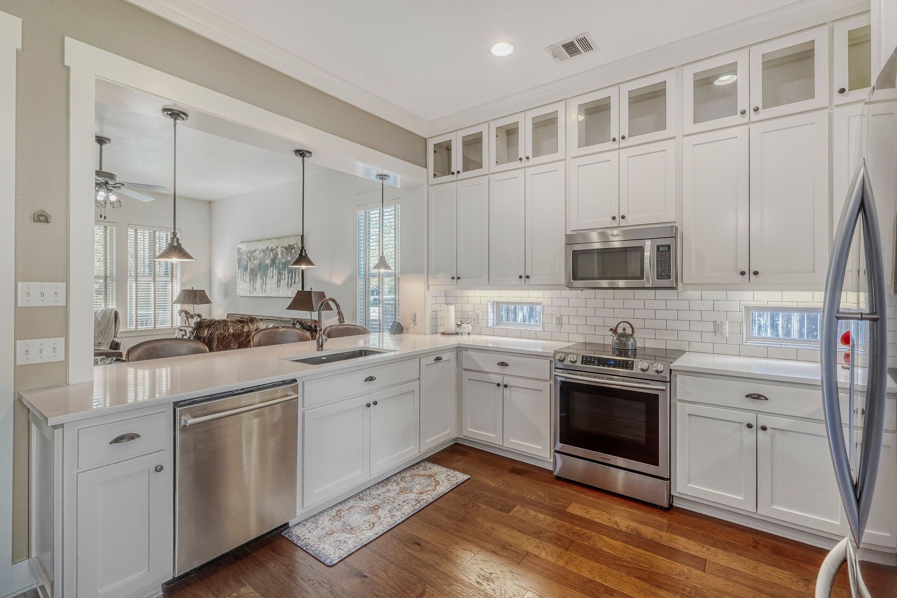 2913 Chisholm Trail Austin, TX 78734 - Photo 8 of 24 a kitchen with stainless steel appliances granite countertop a stove sink and cabinets
