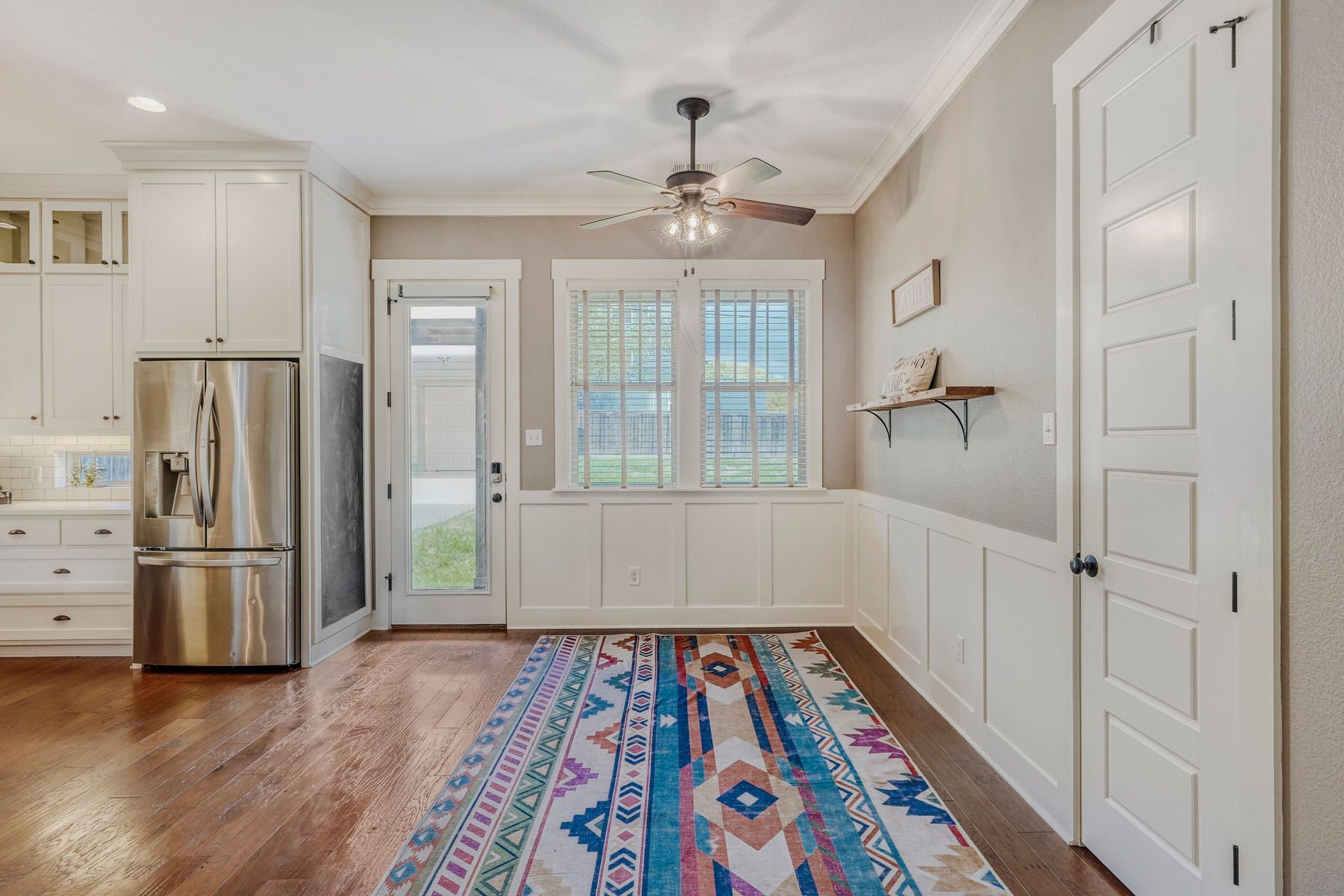 2913 Chisholm Trail Austin, TX 78734 - Photo 9 of 24 a hallway with wooden floor cabinets and a kitchen