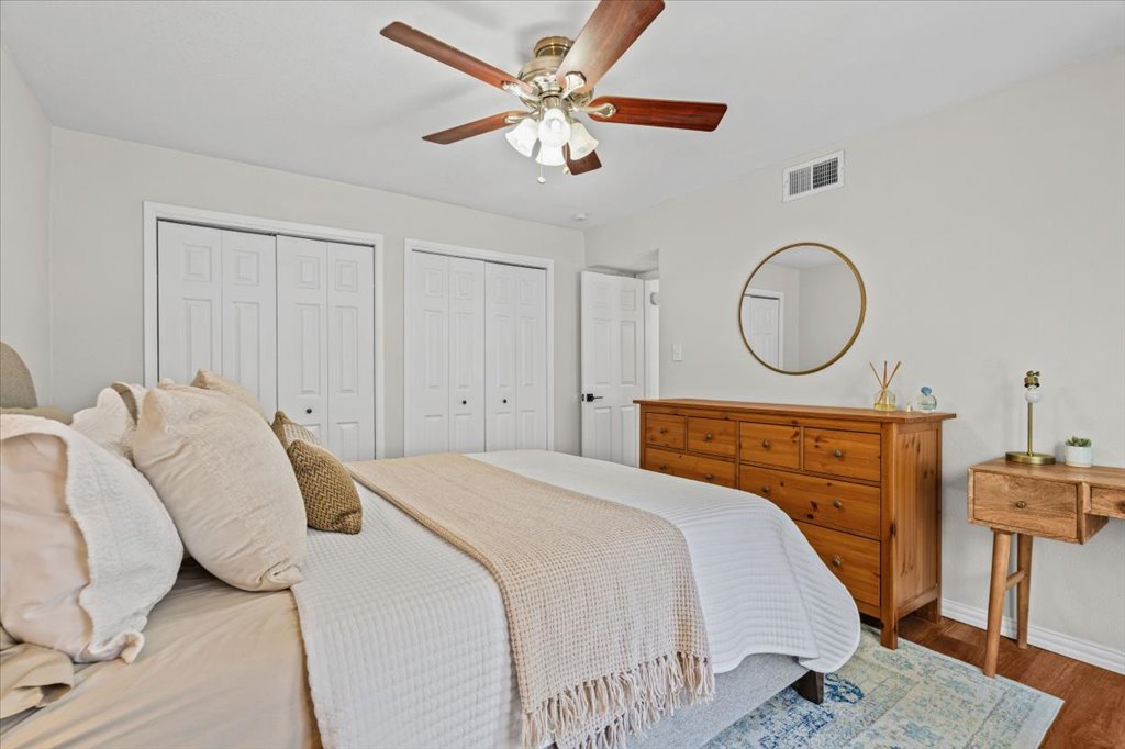 2208 Enfield Road, Unit 107 Austin, TX 78703 - Photo 17 of 35 a bedroom with a bed a mirror and a table