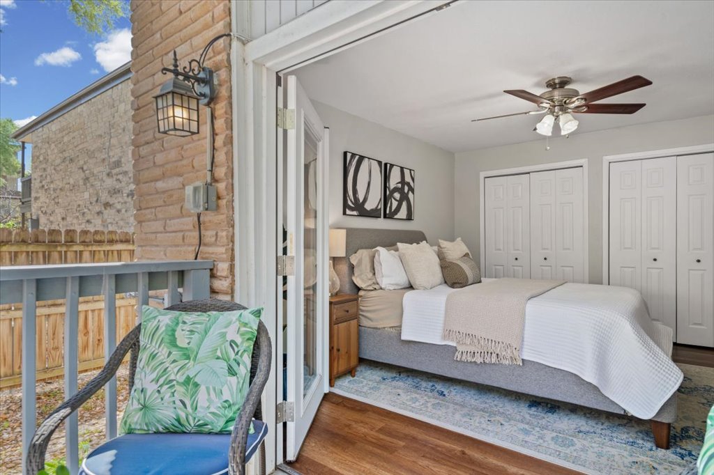 2208 Enfield Road, Unit 107 Austin, TX 78703 - Photo 19 of 35 a bedroom with a bed and a window