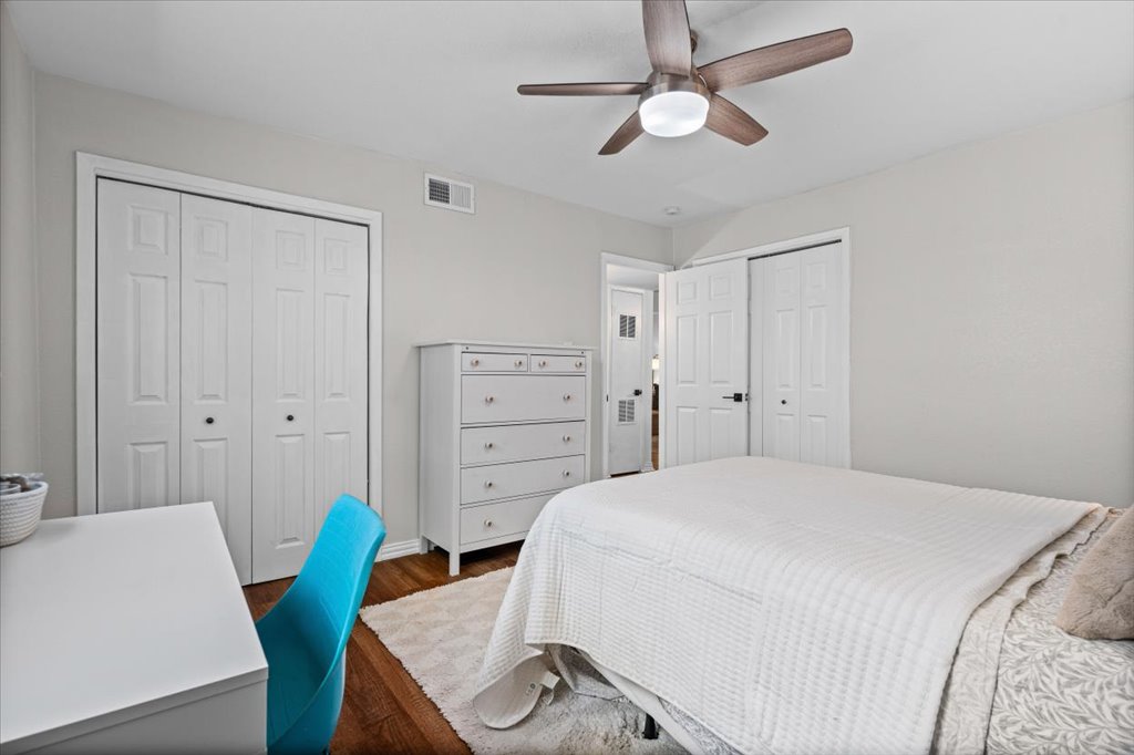 2208 Enfield Road, Unit 107 Austin, TX 78703 - Photo 23 of 35 a bedroom with a bed and a chandelier