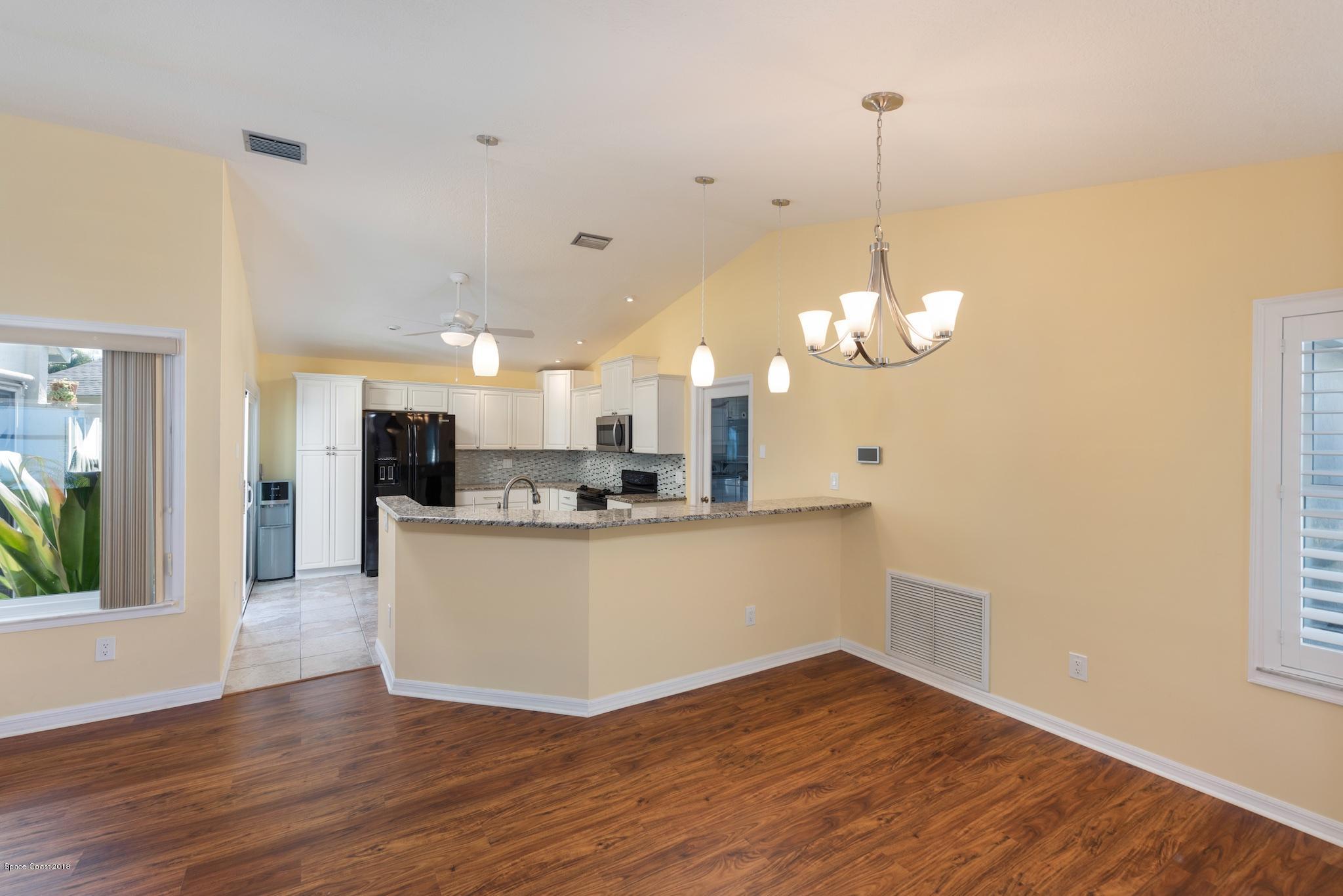 309 Pine Ridge Lane Melbourne, FL 32940 - Photo 6 of 26 Living to Kitchen