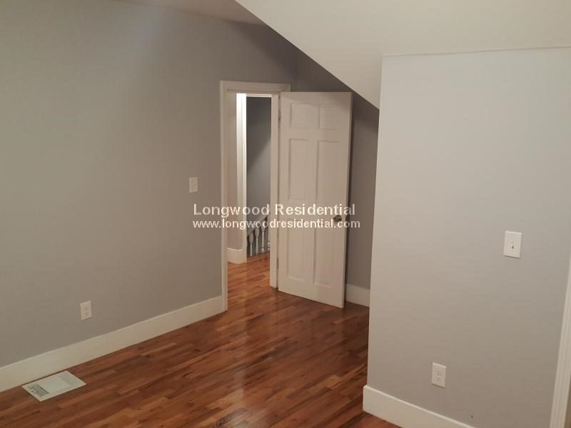 39 Pinckney Street, Unit 3 Somerville, MA 02145 - Photo 14 of 17 wooden floor in an empty room