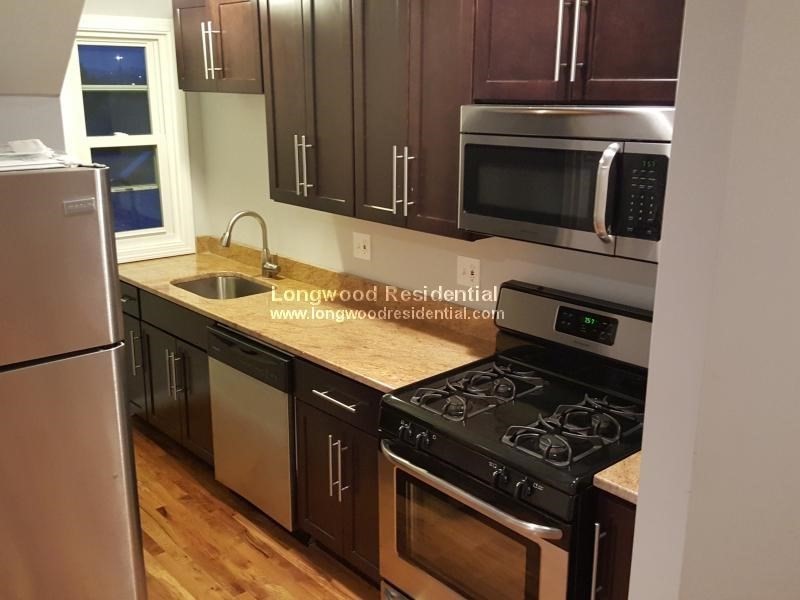 39 Pinckney Street, Unit 3 Somerville, MA 02145 - Photo 2 of 17 a kitchen with a stove and a microwave