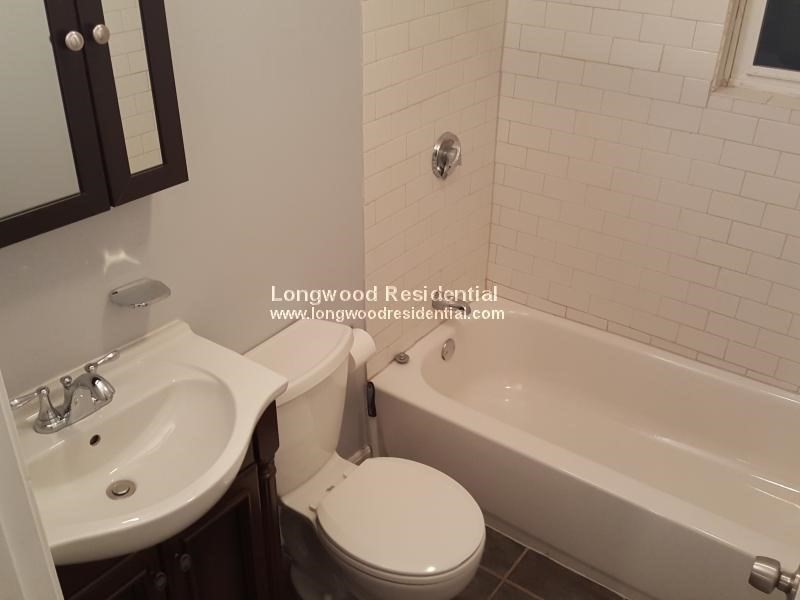 39 Pinckney Street, Unit 3 Somerville, MA 02145 - Photo 7 of 17 a white toilet sitting next to a bathroom sink
