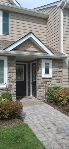 a front view of a house with a garden
