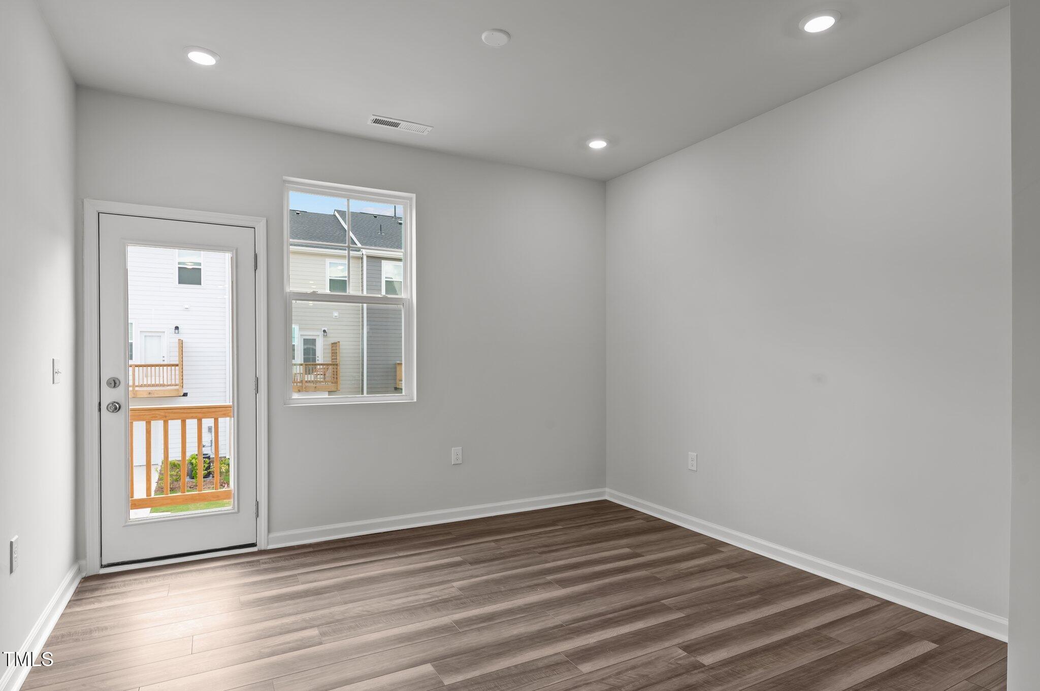 331 Devon Clfs Drive Wake Forest, NC 27587 - Photo 10 of 35 a view of an empty room with wooden floor and a window