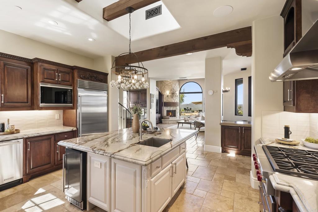 18320 Via Ambiente Rancho Santa Fe, CA 92067 - Photo 11 of 59 a kitchen with stainless steel appliances granite countertop a sink and a refrigerator