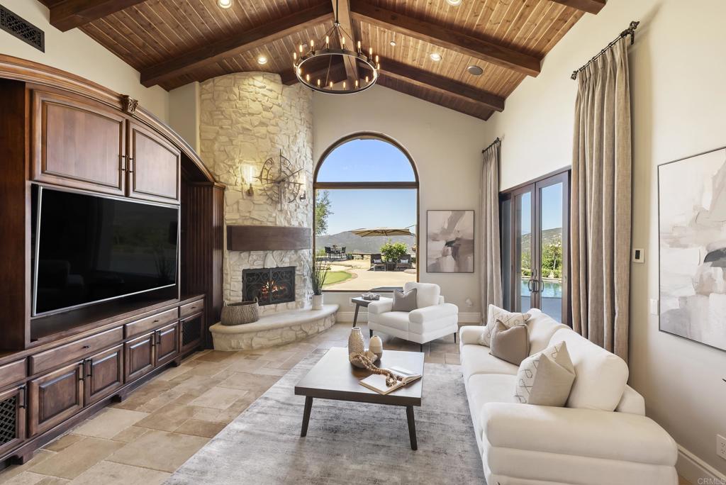 18320 Via Ambiente Rancho Santa Fe, CA 92067 - Photo 14 of 59 a living room with furniture a flat screen tv and a floor to ceiling window