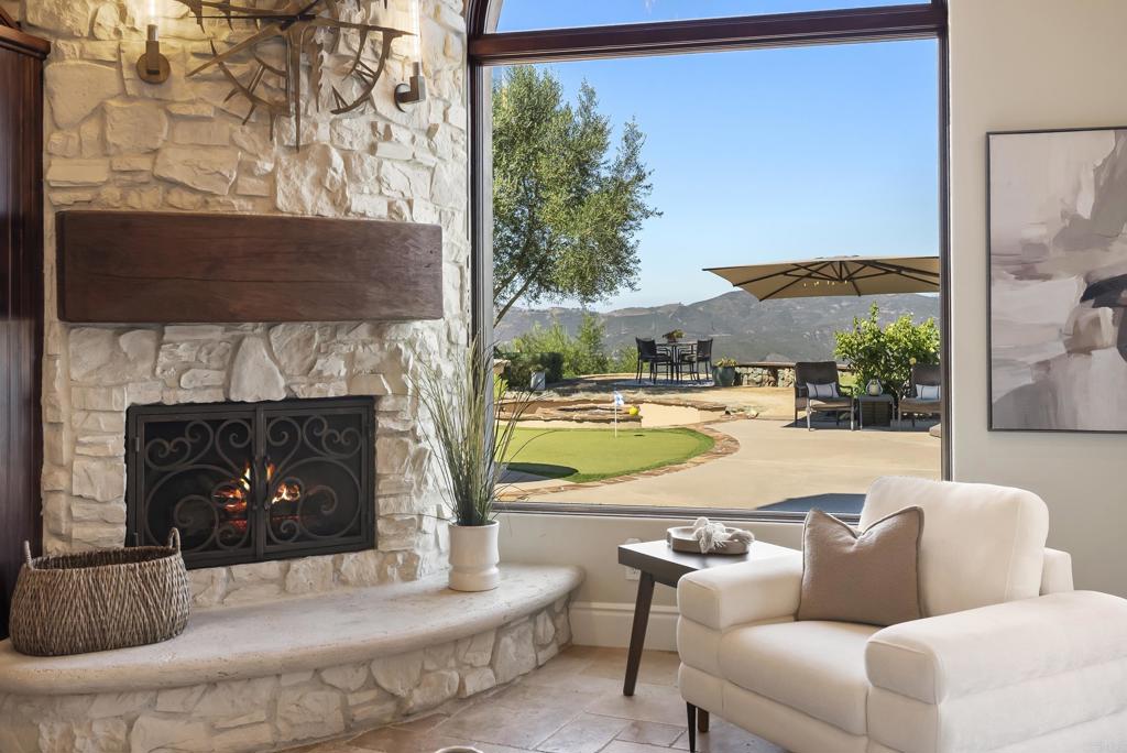 18320 Via Ambiente Rancho Santa Fe, CA 92067 - Photo 16 of 59 a living room with furniture and a fireplace