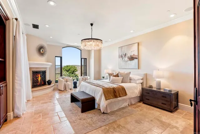 a spacious bedroom with a large bed and a fireplace