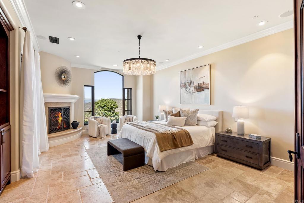 18320 Via Ambiente Rancho Santa Fe, CA 92067 - Photo 21 of 59 a large bedroom with a bed and a fireplace