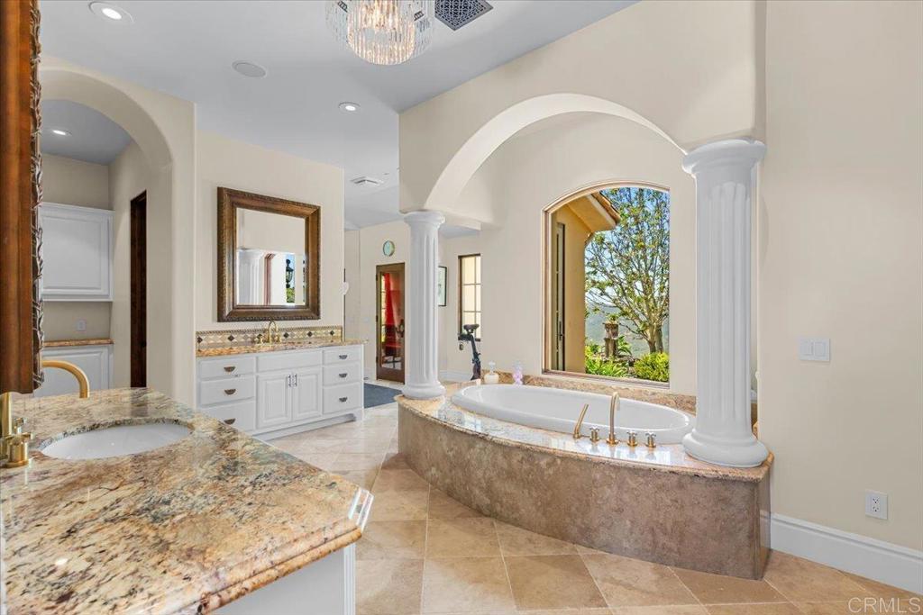 18320 Via Ambiente Rancho Santa Fe, CA 92067 - Photo 24 of 59 a large spacious bathroom with a granite countertop tub and a large window