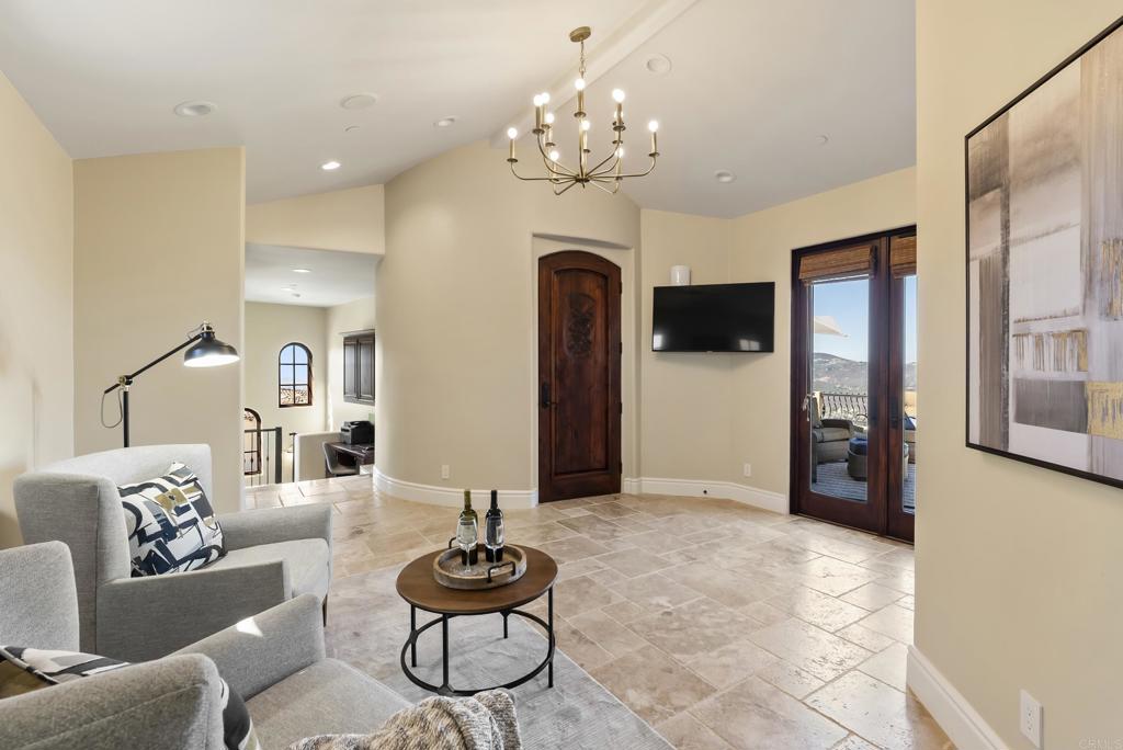 18320 Via Ambiente Rancho Santa Fe, CA 92067 - Photo 35 of 59 a living room with furniture a chandelier and a chandelier