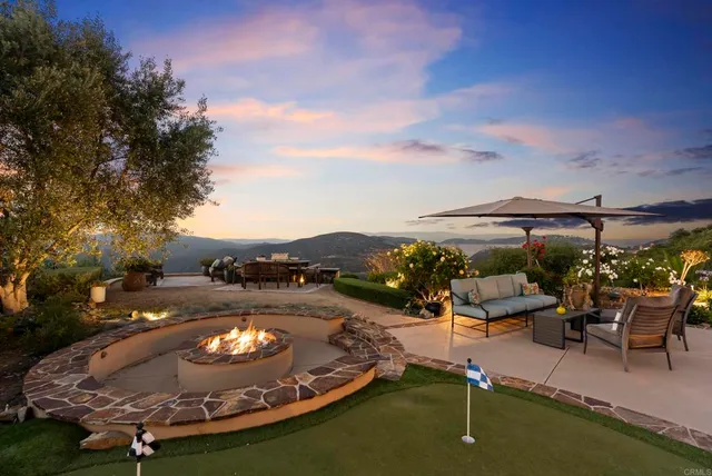 a view of a lake with a table and chairs