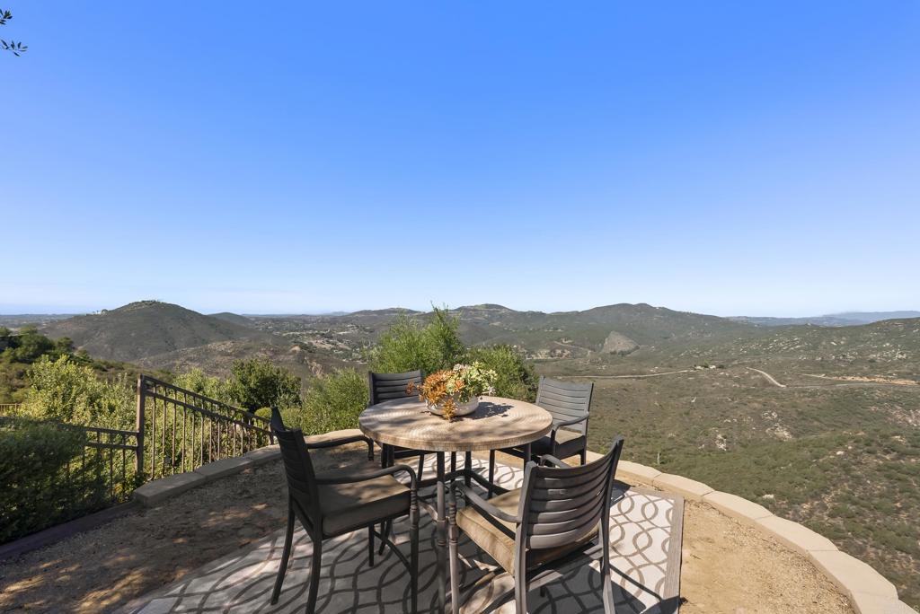 18320 Via Ambiente Rancho Santa Fe, CA 92067 - Photo 50 of 59 a view of a lake with a table and chairs