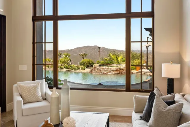 a living room with couches and a dining table with a window