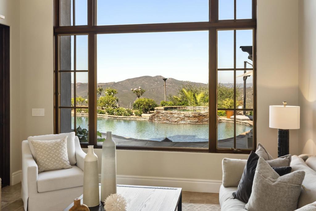 18320 Via Ambiente Rancho Santa Fe, CA 92067 - Photo 8 of 59 a living room with couches and a dining table with a window