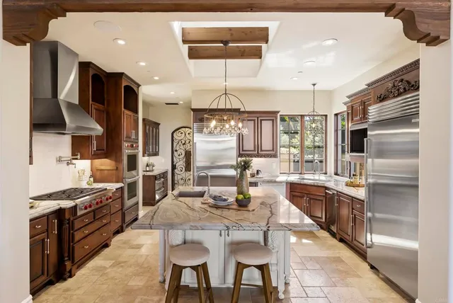 a kitchen with stainless steel appliances kitchen island granite countertop a sink and cabinets