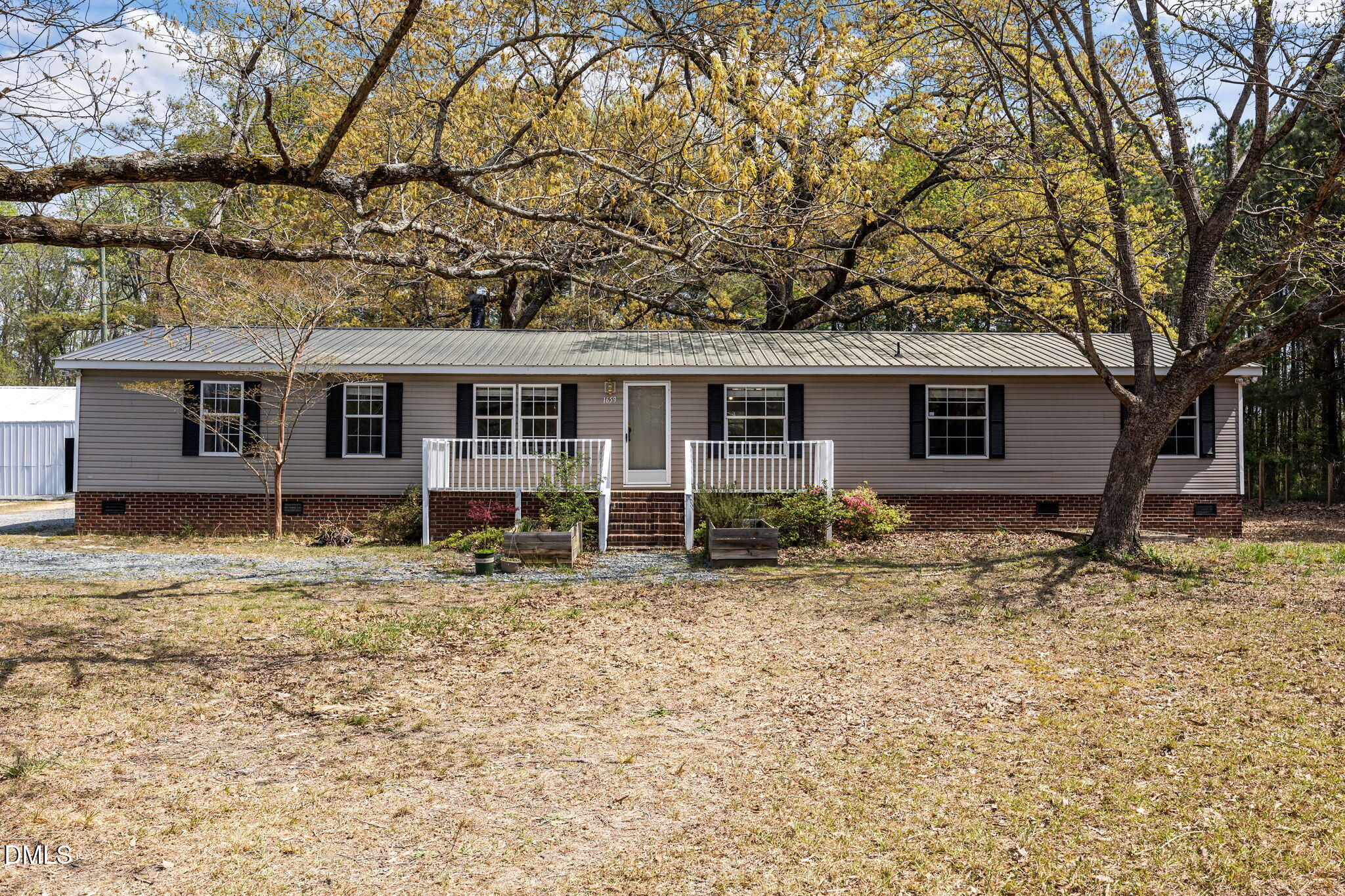 1659 Adcock Road Lillington, NC 27546 - Photo 1 of 34 front view of a house with a dry yard