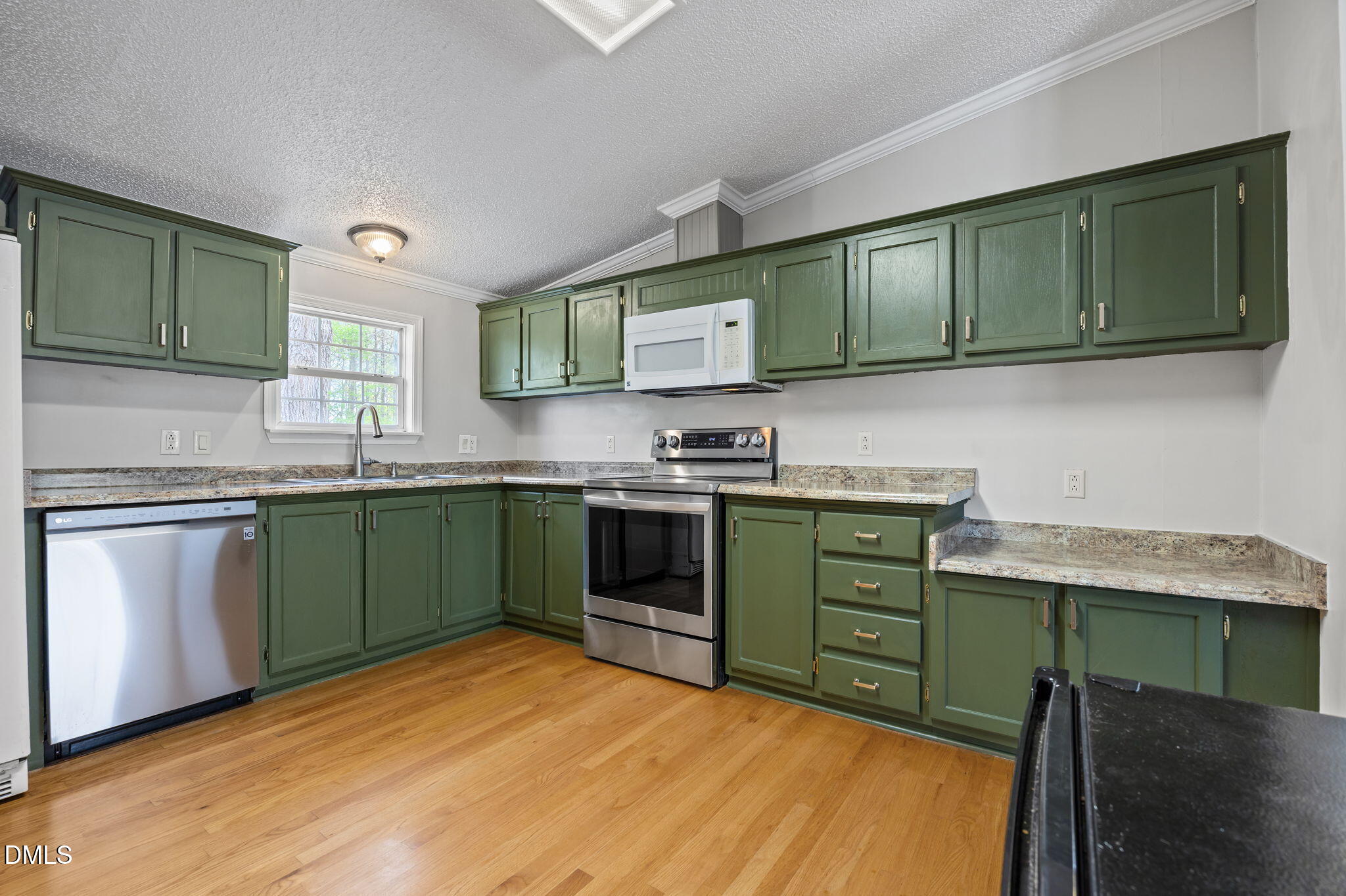 1659 Adcock Road Lillington, NC 27546 - Photo 11 of 34 a kitchen with granite countertop a sink cabinets and stainless steel appliances