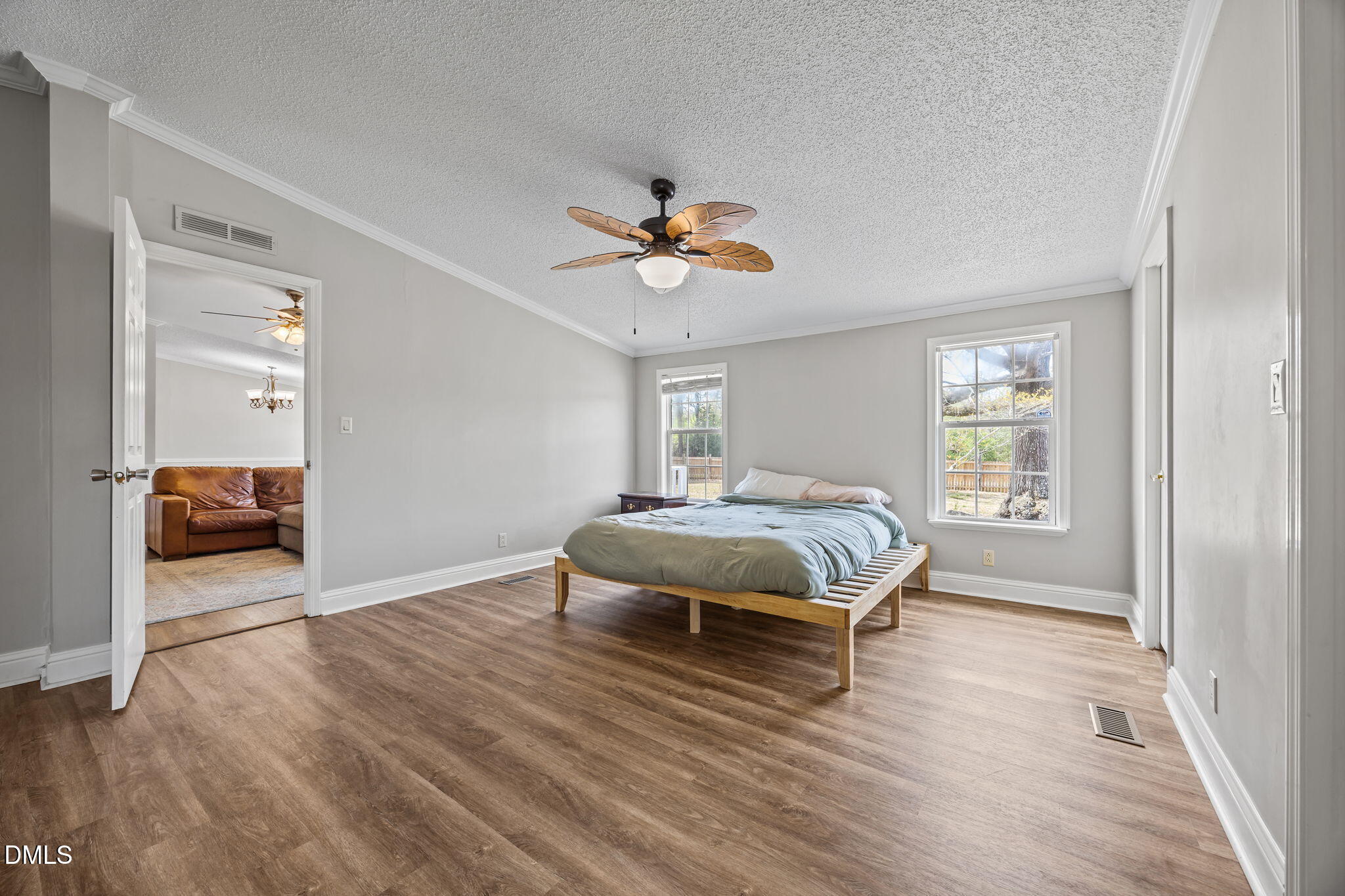1659 Adcock Road Lillington, NC 27546 - Photo 13 of 34 a bedroom with a bed and a chandelier