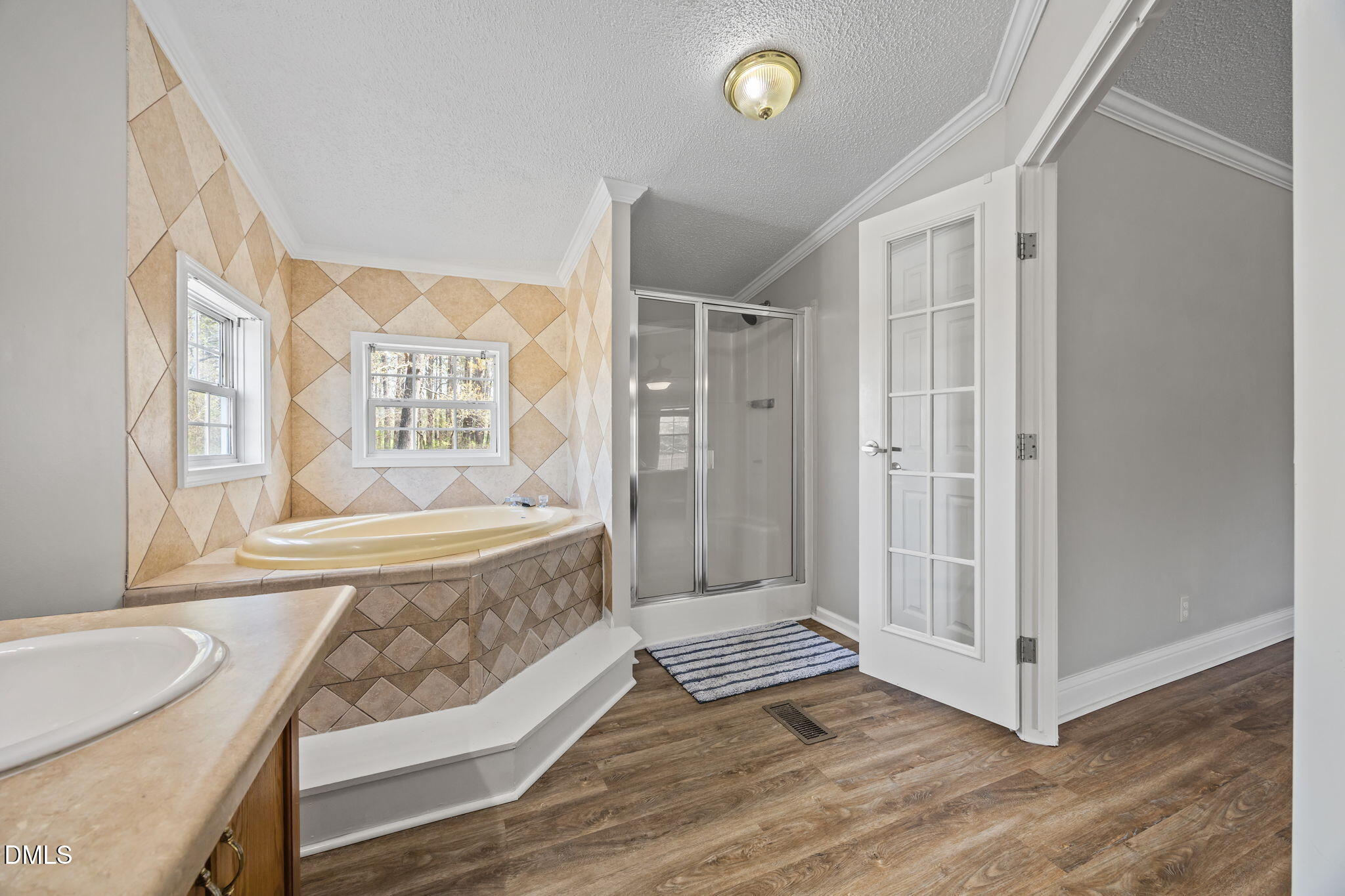 1659 Adcock Road Lillington, NC 27546 - Photo 14 of 34 a spacious bathroom with a tub shower and mirror