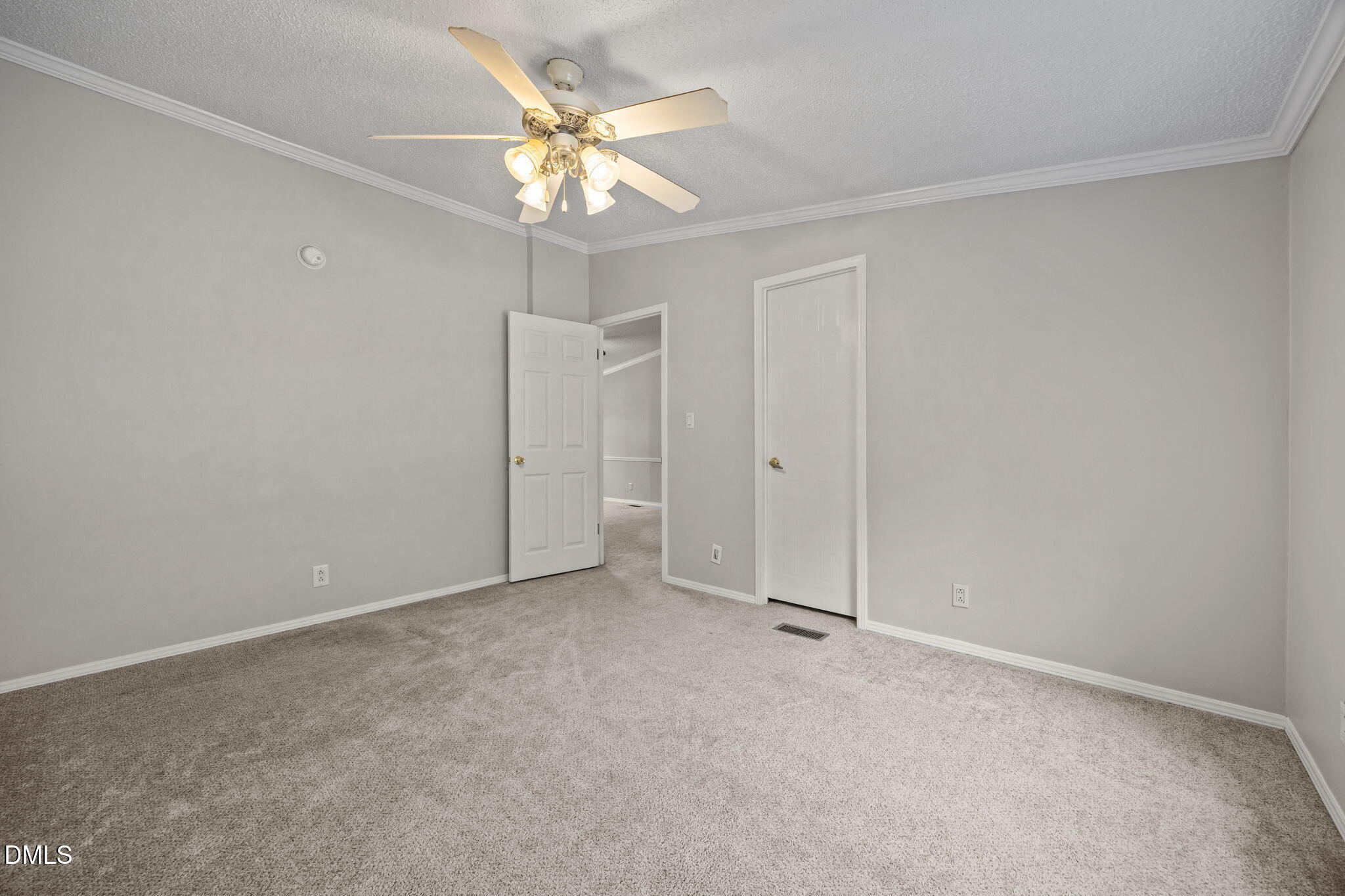 1659 Adcock Road Lillington, NC 27546 - Photo 18 of 34 an empty room with a chandelier fan and closet area