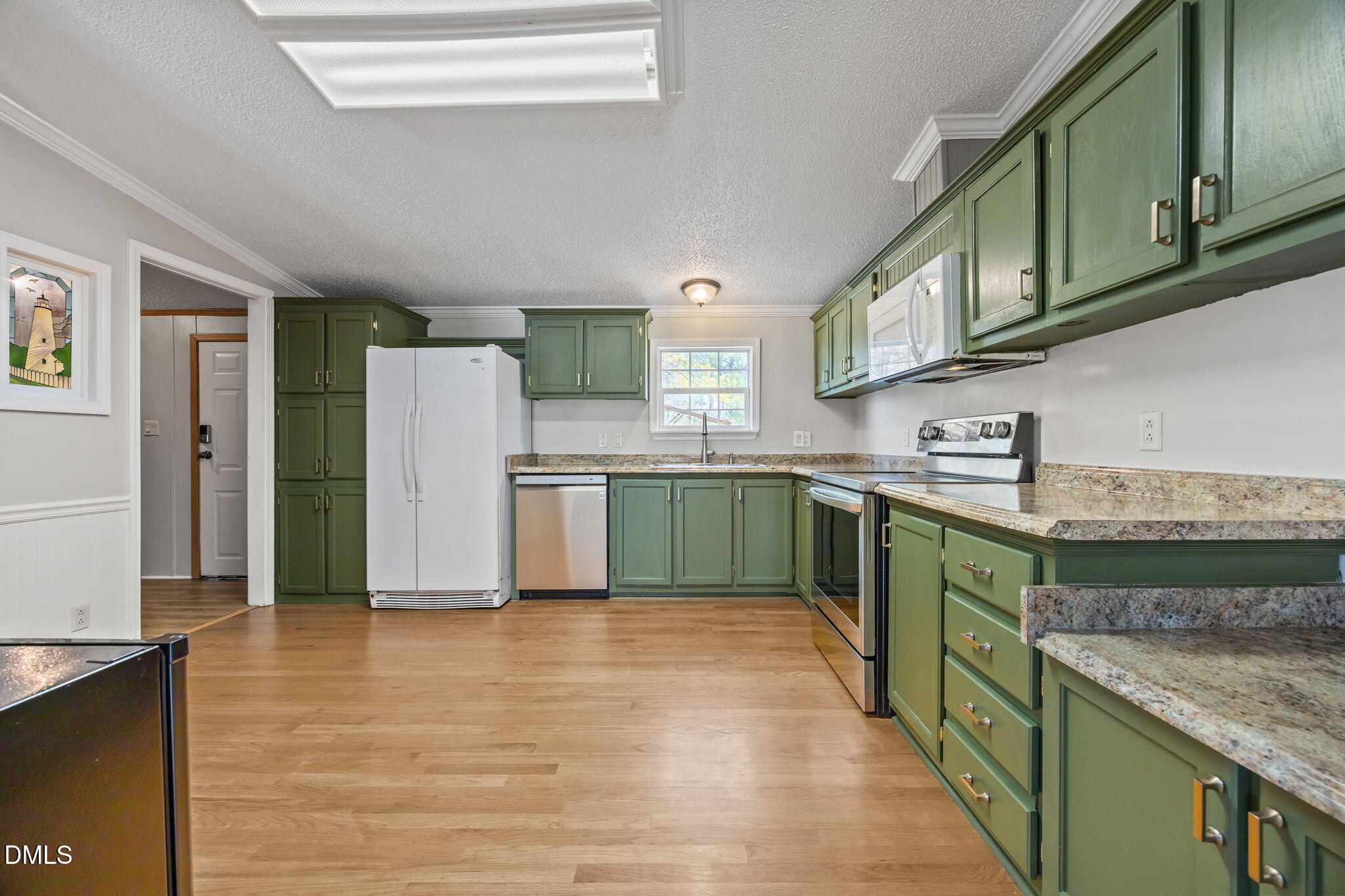 1659 Adcock Road Lillington, NC 27546 - Photo 9 of 34 a kitchen with stainless steel appliances granite countertop a refrigerator and a sink
