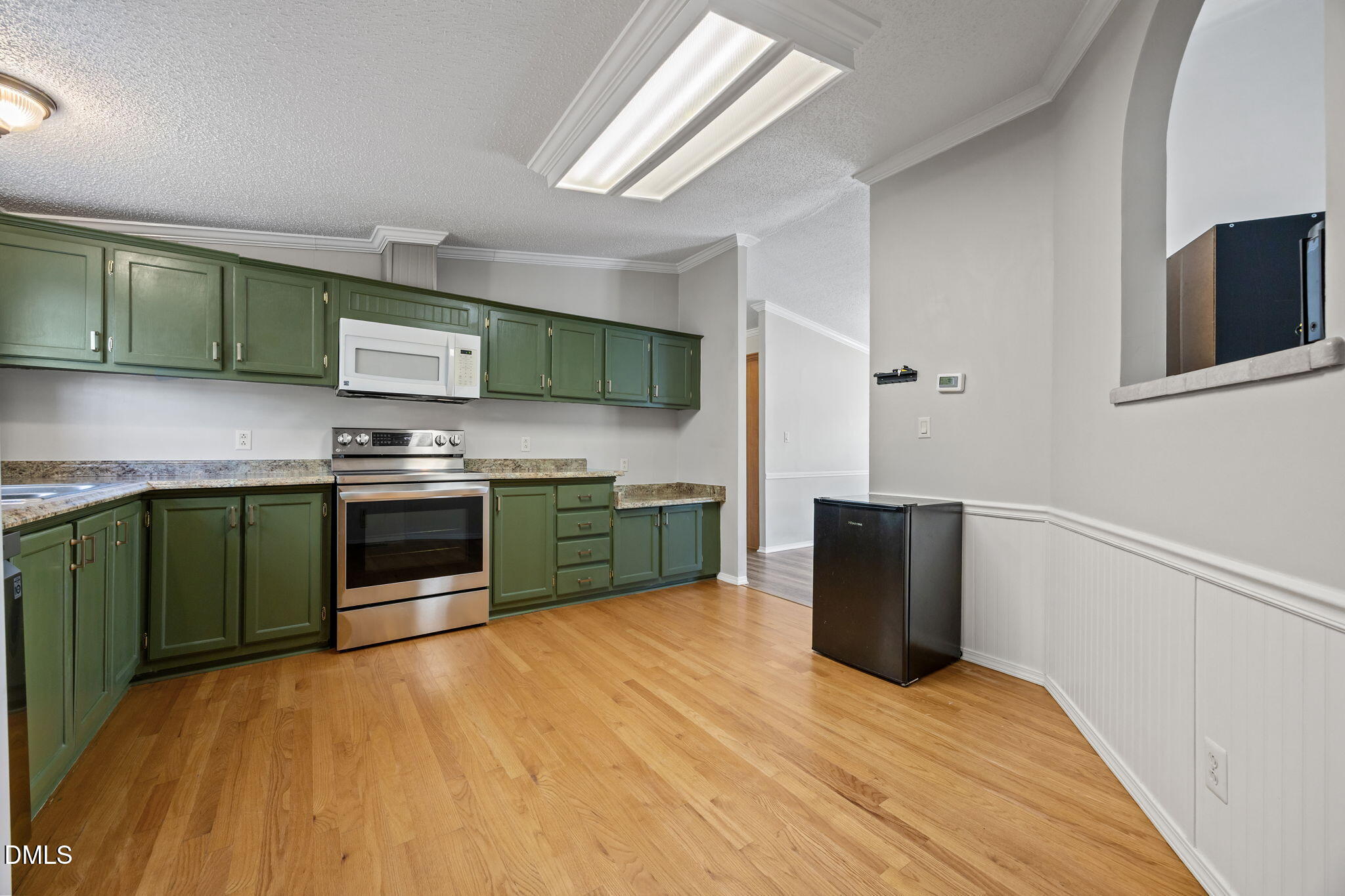 1659 Adcock Road Lillington, NC 27546 - Photo 10 of 34 a kitchen with stainless steel appliances and a wooden floor