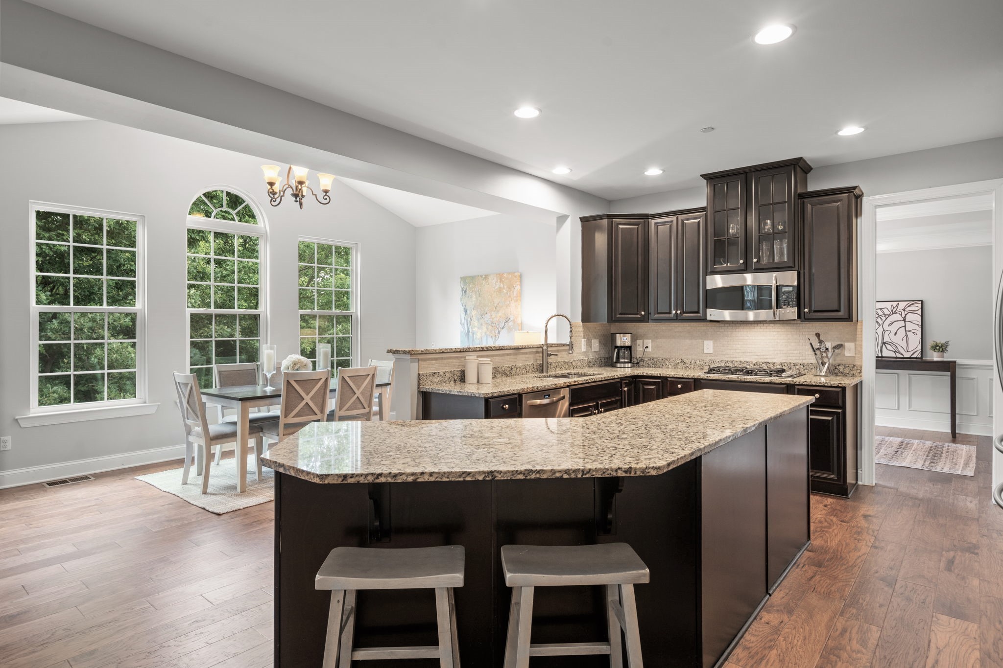 121 Stream Valley Boulevard Franklin, TN 37064 - Photo 12 of 60 a large kitchen with kitchen island granite countertop a stove a sink a dining table and chairs