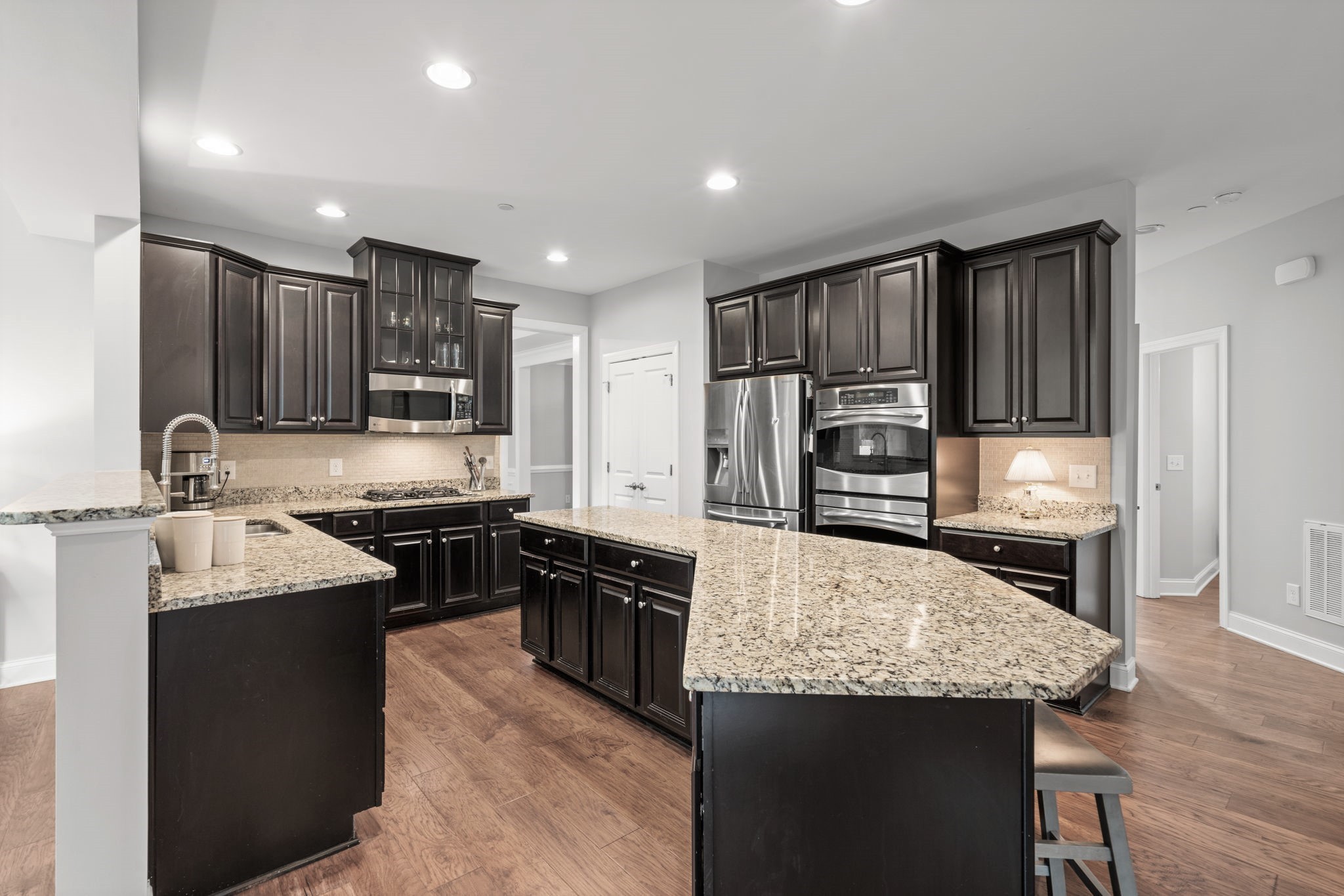 121 Stream Valley Boulevard Franklin, TN 37064 - Photo 14 of 60 a kitchen with kitchen island granite countertop stainless steel appliances and wooden cabinets