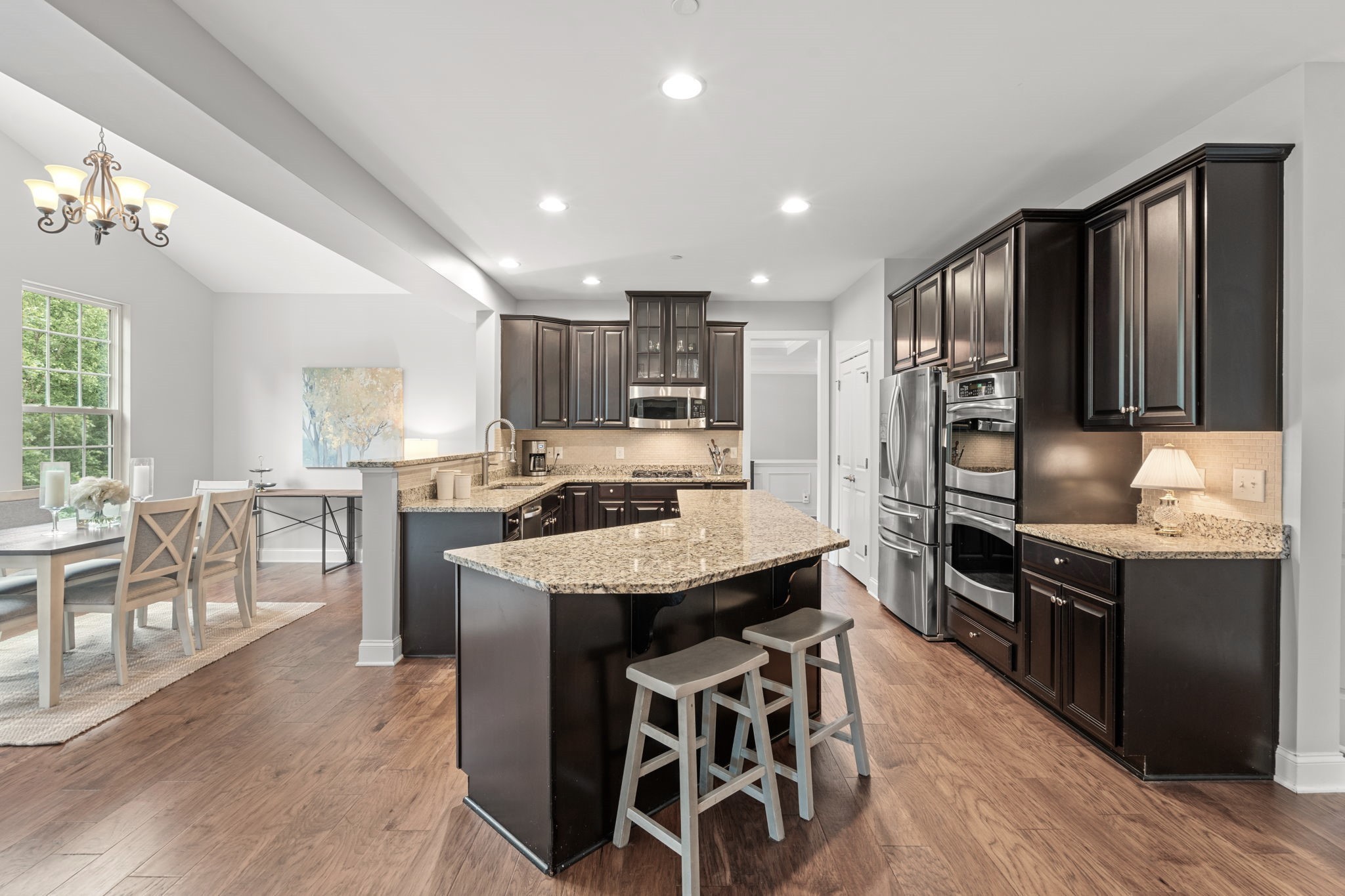 121 Stream Valley Boulevard Franklin, TN 37064 - Photo 15 of 60 a kitchen with stainless steel appliances kitchen island granite countertop a stove refrigerator and cabinets