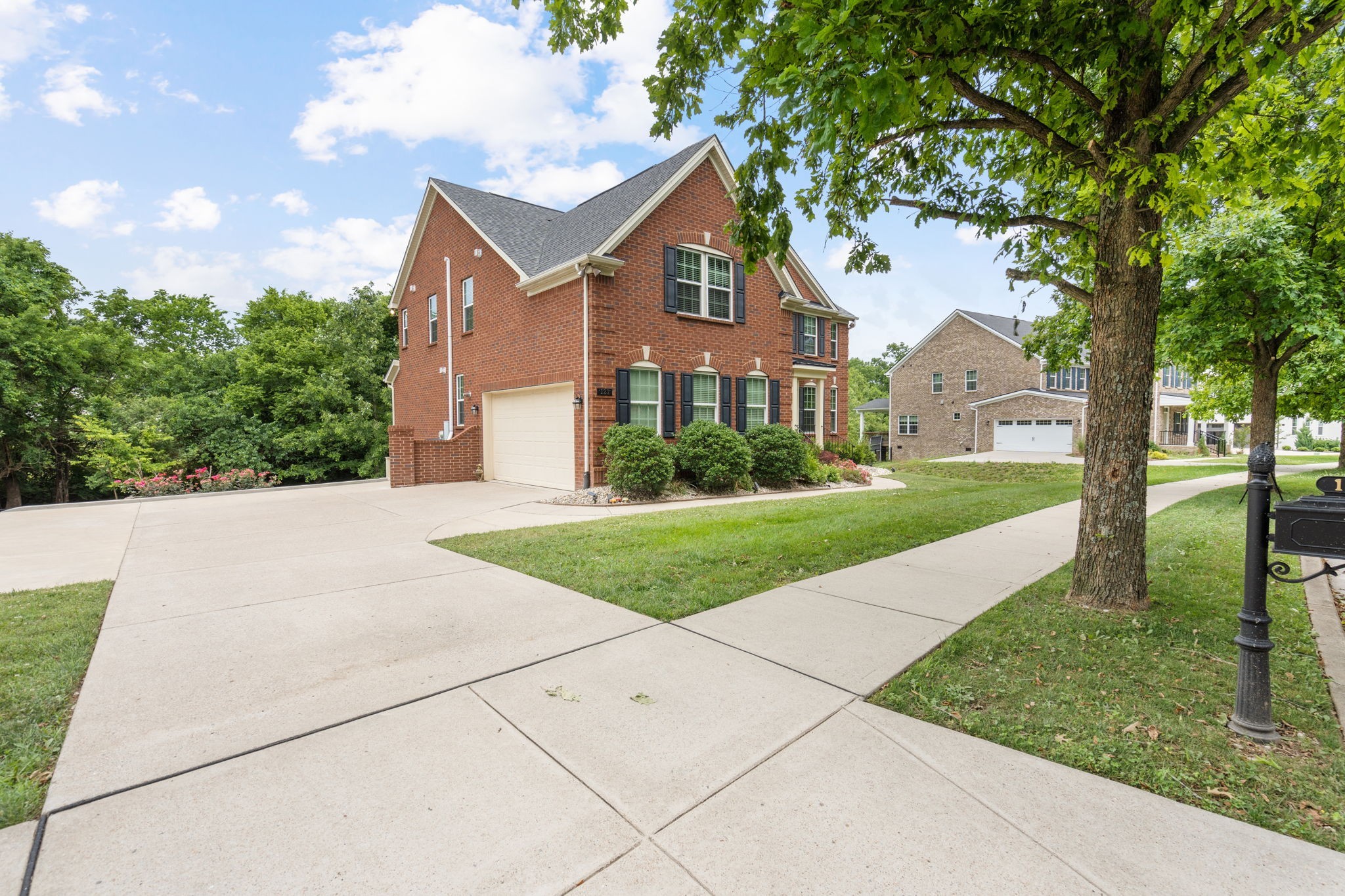 121 Stream Valley Boulevard Franklin, TN 37064 - Photo 3 of 60 a front view of a house with a yard and trees