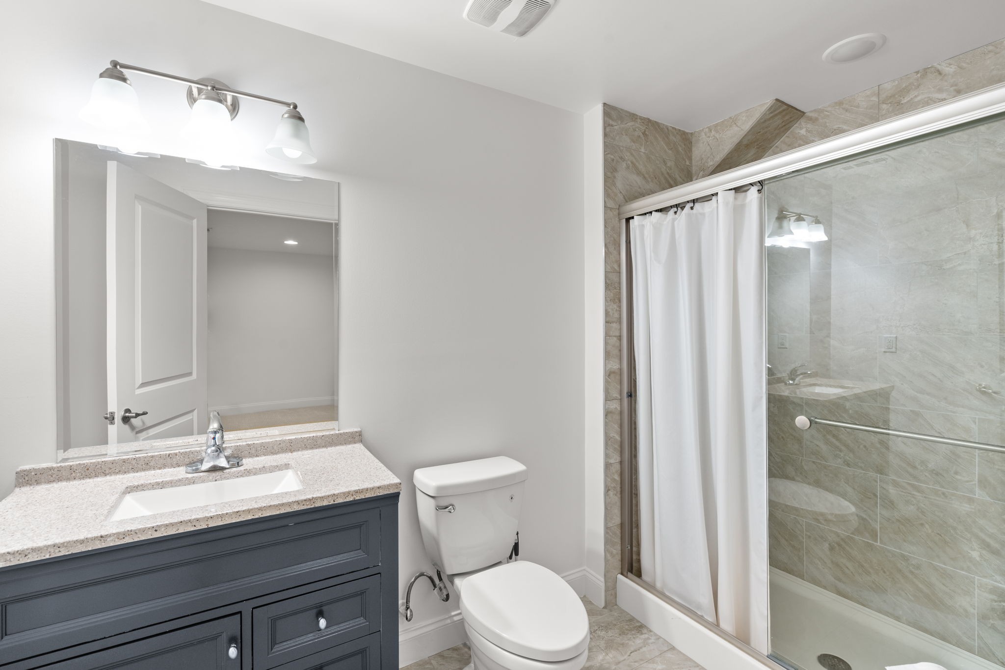 121 Stream Valley Boulevard Franklin, TN 37064 - Photo 38 of 60 a bathroom with a granite countertop sink toilet a mirror and shower