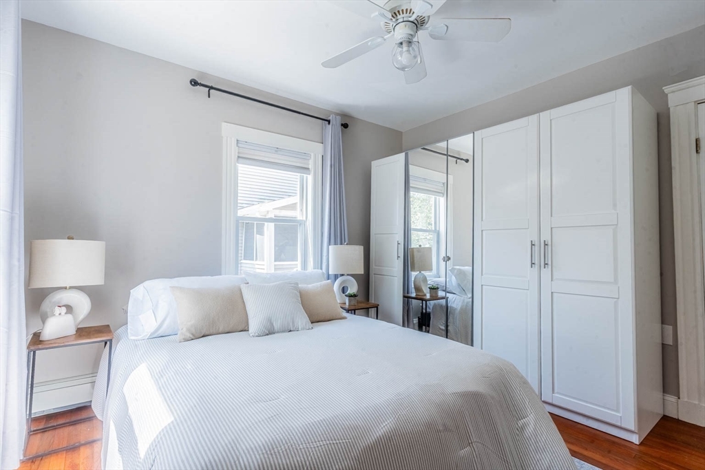 51 Edwin Road Waltham, MA 02453 - Photo 14 of 35 a bedroom with a large bed and a chandelier