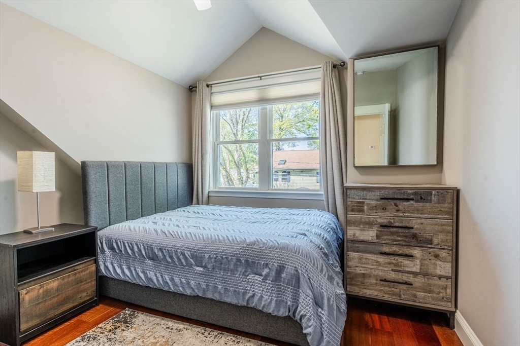 51 Edwin Road Waltham, MA 02453 - Photo 22 of 35 a bedroom with a bed a dresser and a large window