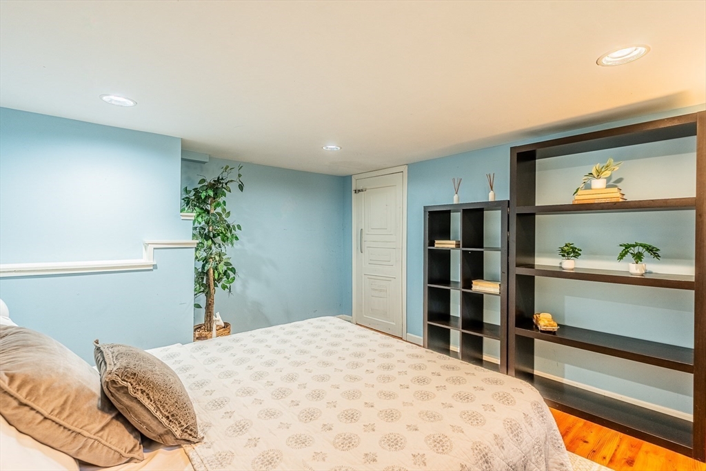 51 Edwin Road Waltham, MA 02453 - Photo 27 of 35 a bedroom with a bed and a potted plant