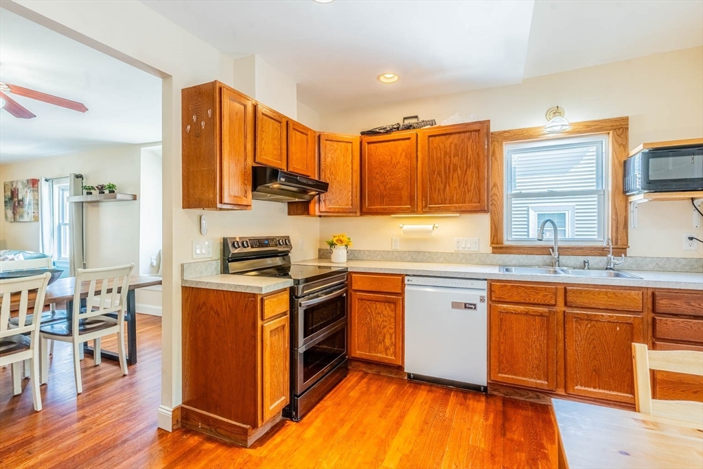 51 Edwin Road Waltham, MA 02453 - Photo 8 of 35 a kitchen with stainless steel appliances granite countertop a stove a sink dishwasher and a refrigerator