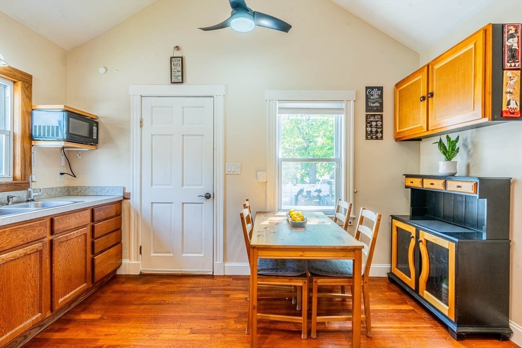 51 Edwin Road Waltham, MA 02453 - Photo 9 of 35 a kitchen with stainless steel appliances wooden floor dining table and chairs