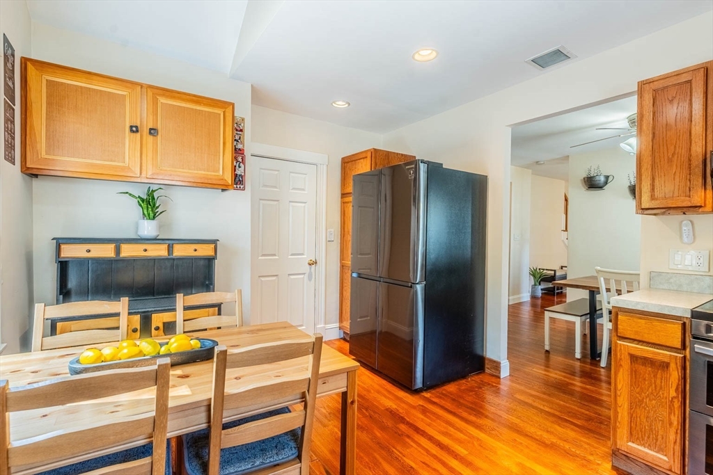 51 Edwin Road Waltham, MA 02453 - Photo 10 of 35 a kitchen with stainless steel appliances granite countertop a refrigerator and a stove top oven