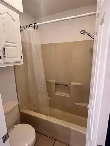 a bathroom with a shower a toilet and a sink