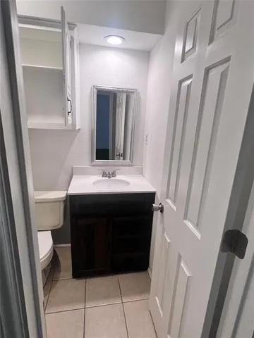 a bathroom with a sink a mirror and a vanity
