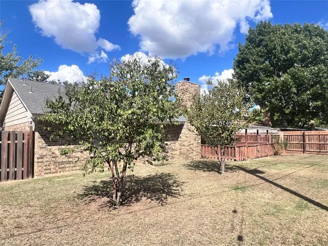 a view of a yard with a tree