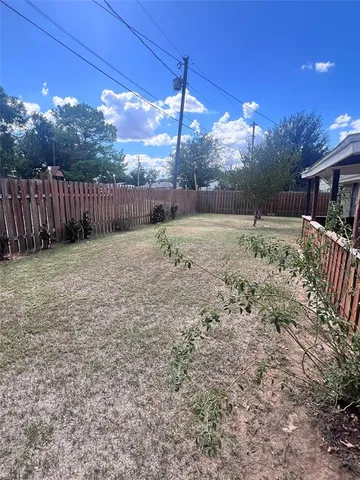 a backyard of a house with a yard and outdoor seating