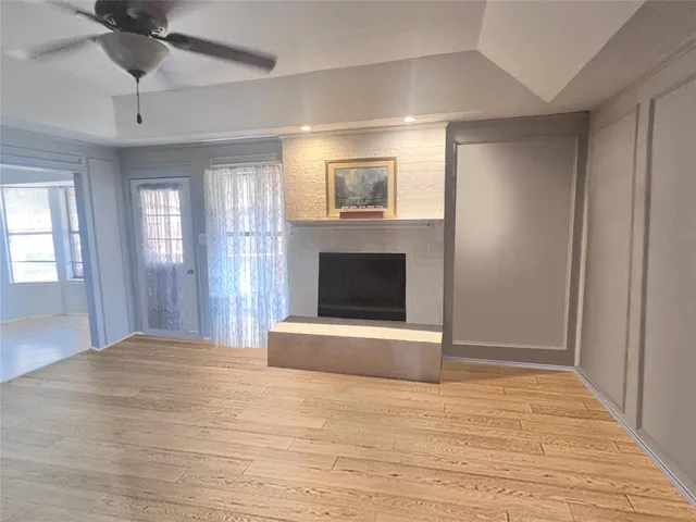 a view of an empty room with window and fireplace