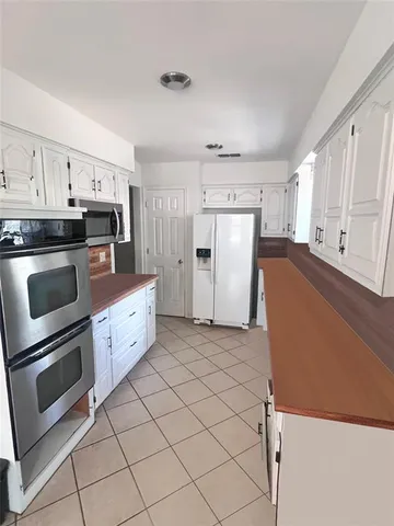a kitchen with granite countertop cabinets and steel stainless steel appliances