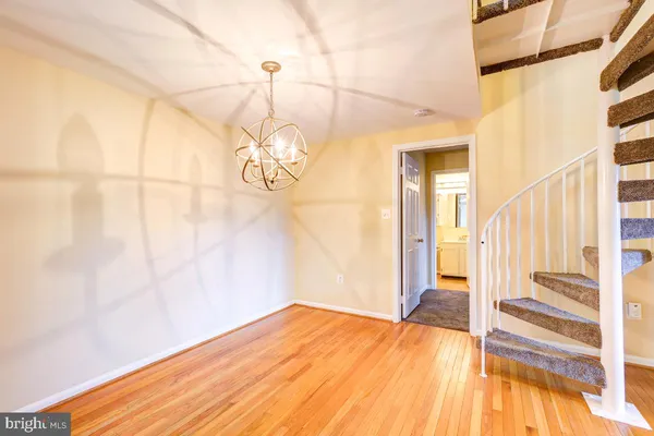 a view of a room with wooden floor and door